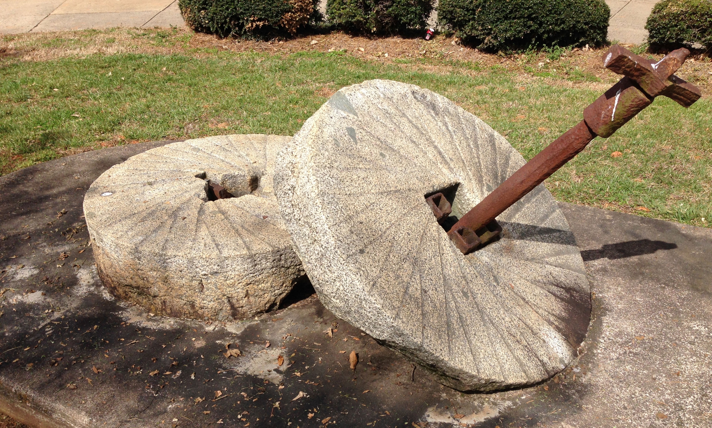 Millstones from the I.N. Alexander mill, built in the 1850s, now sit at the entrance to Myers Park High School. Photo: Mary Newsom